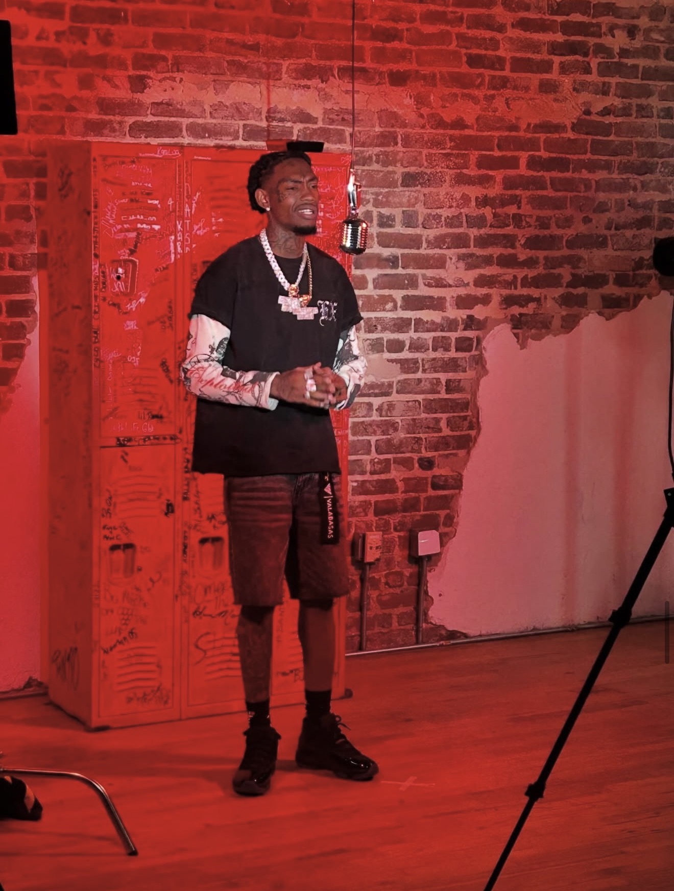 RISKTaker SANE standing in a red-lit studio room